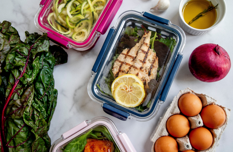 A structured intermittent fasting meal plan setup with fresh food and a tracker